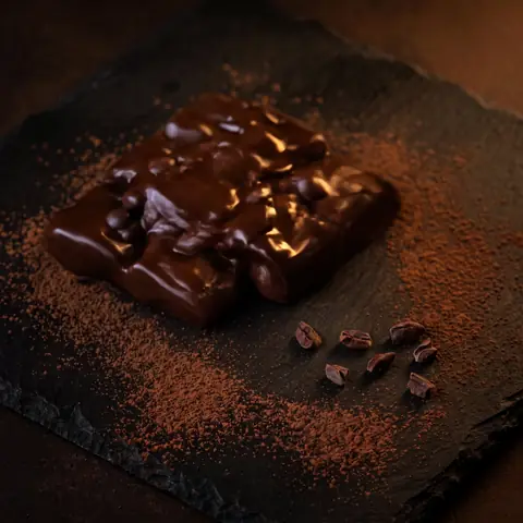 Dark beans melting into a glossy pool