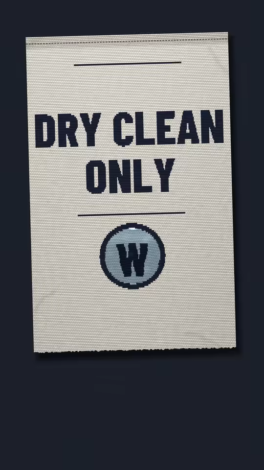 DRY CLEANING ISN’T DRY at 37.4 seconds: a woven DRY CLEAN ONLY tag with a W inside its circle, filled with water.